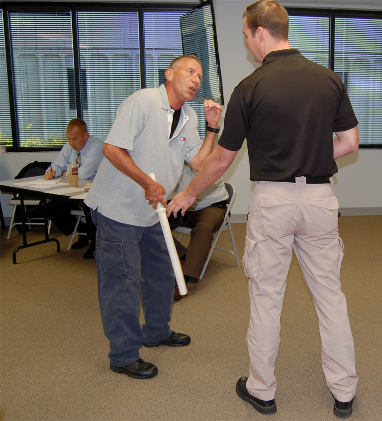 Photo of two participants in a role-playing scenario.