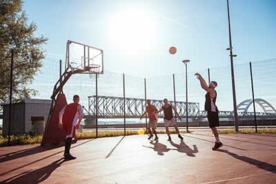 A two on two pick-up basketball game.