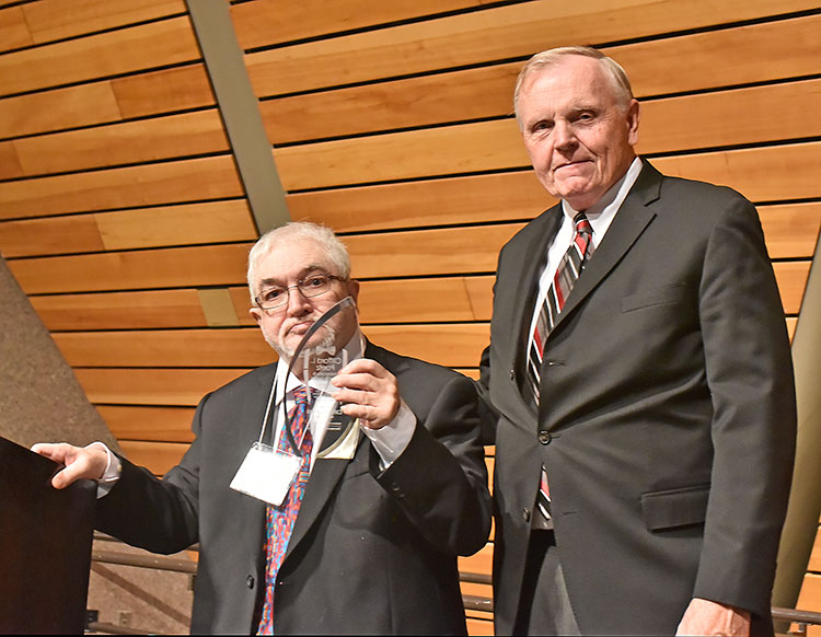 Photo of Cliff Poetz receiving ICI’s inaugural Clifford L. Poetz Advocacy & Service Award. Standing with Cliff is ICI director David R. Johnson.